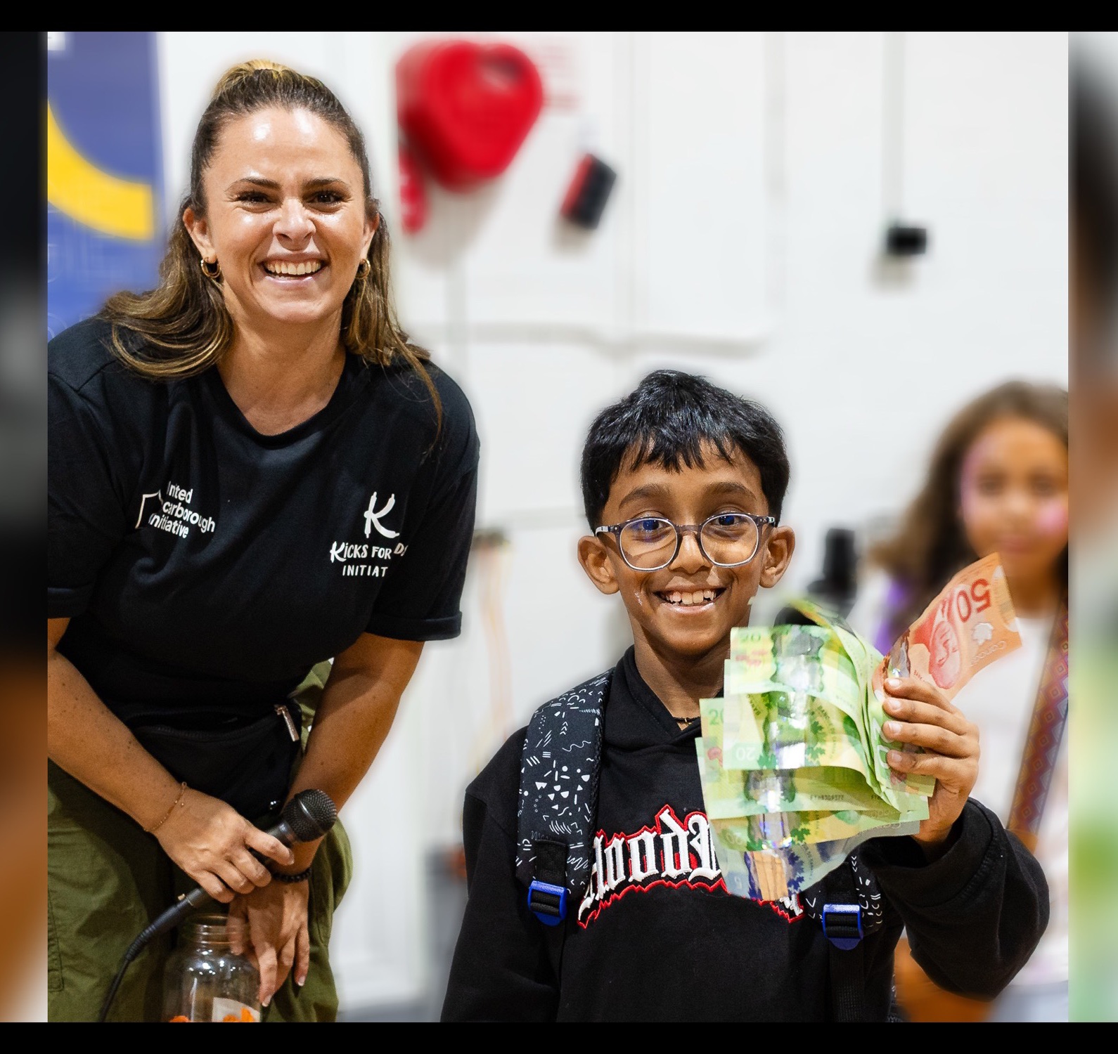 Tara presenting financial literacy to a young student